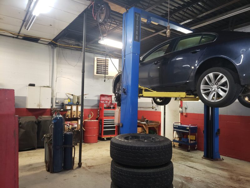 Vehicle on a lift inside Lansing Car Care Center