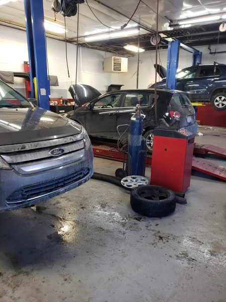 Vehicles being serviced inside Lansing Car Care Center